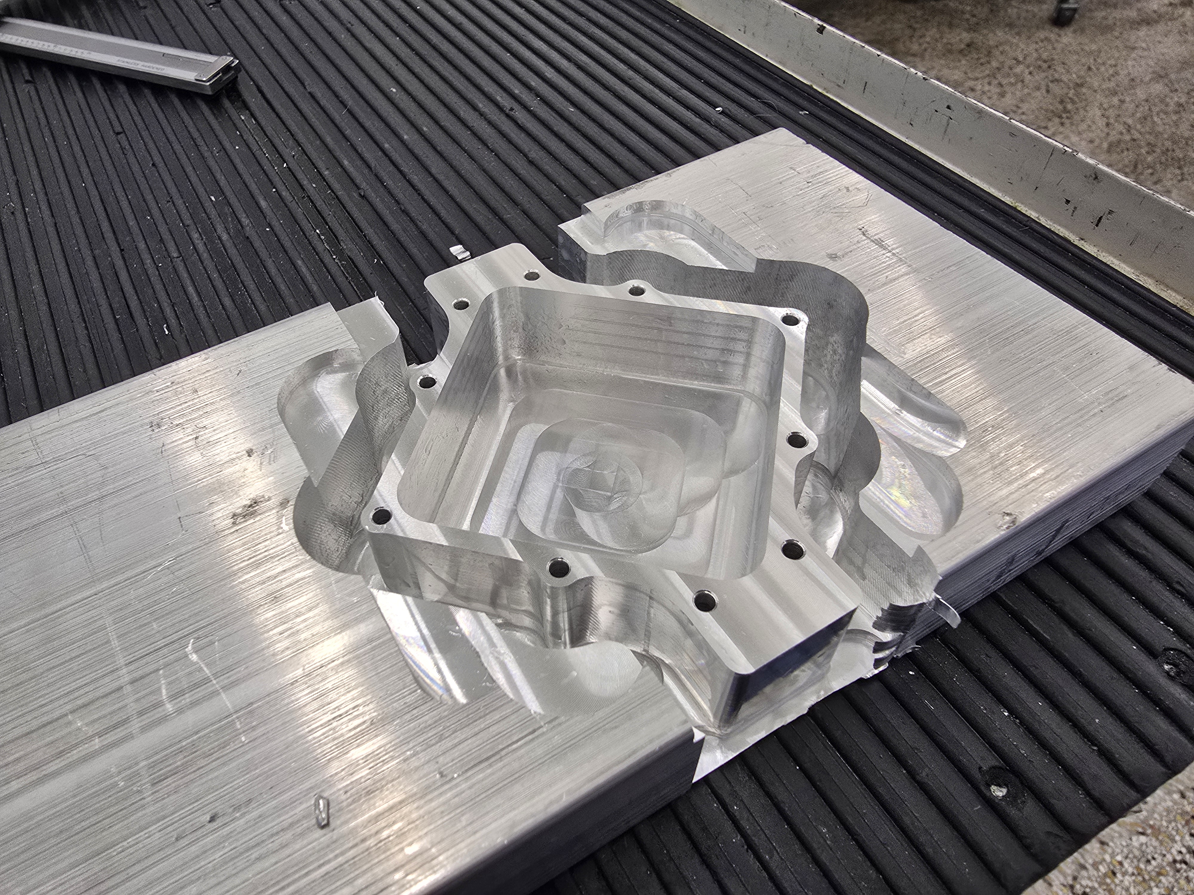 Vacuum chamber after milling, still attached to the stock
