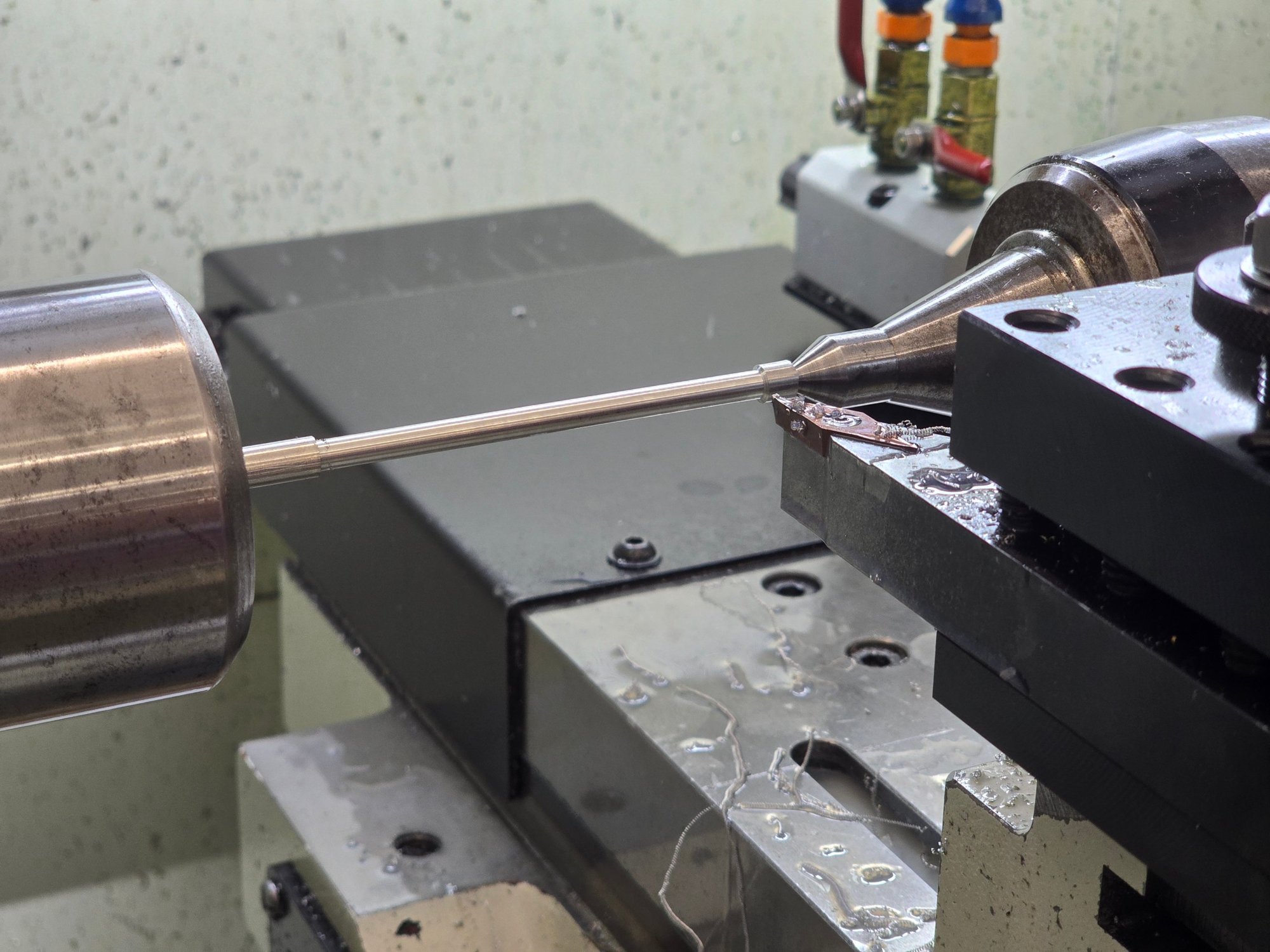Aluminum rod being turned on the lathe